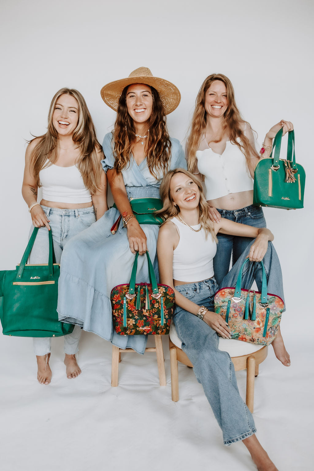 4 models holding handmade handbags by Shawanna Meeks made of cork fabric 