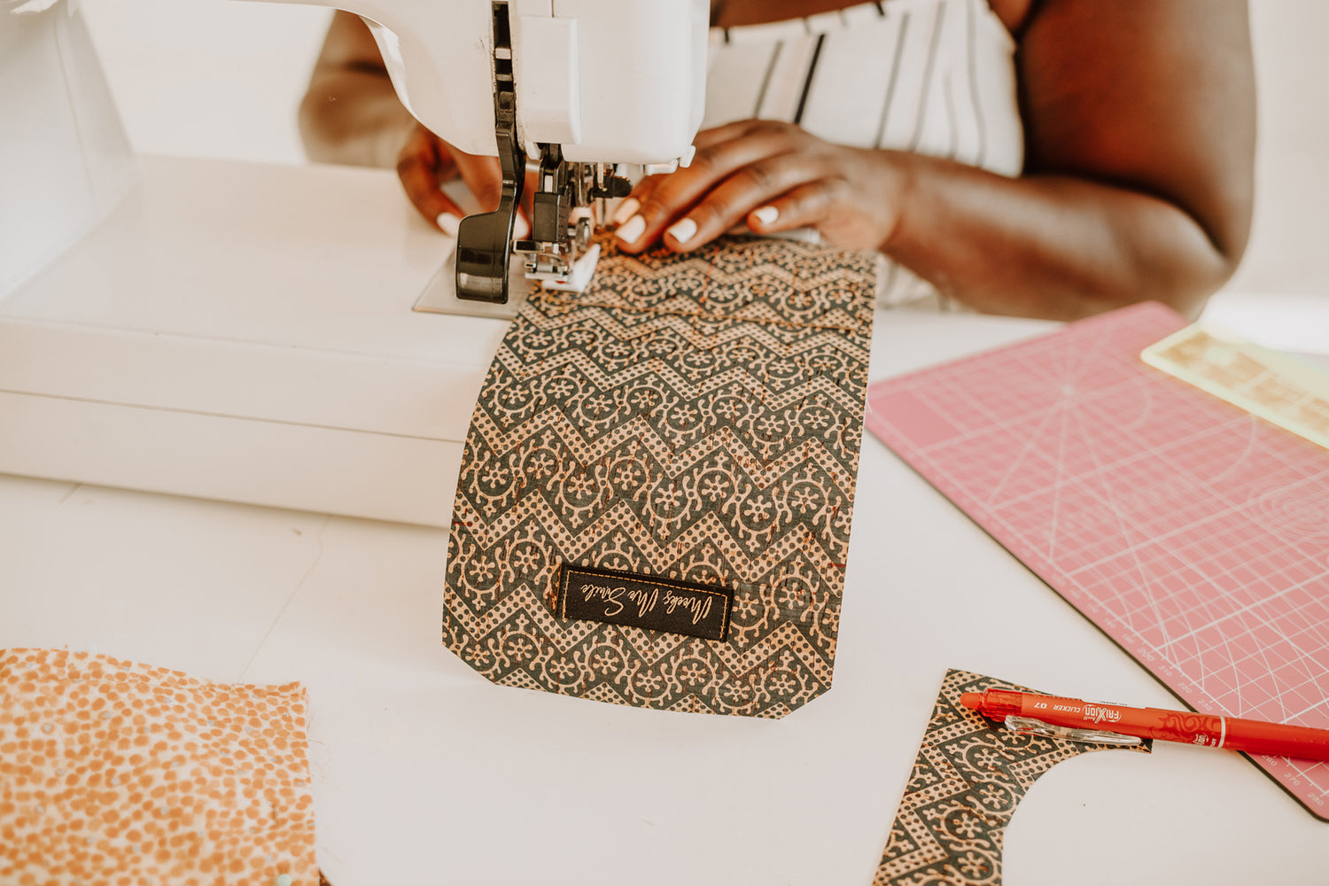 Shawanna Meeks sewing a cork wallet